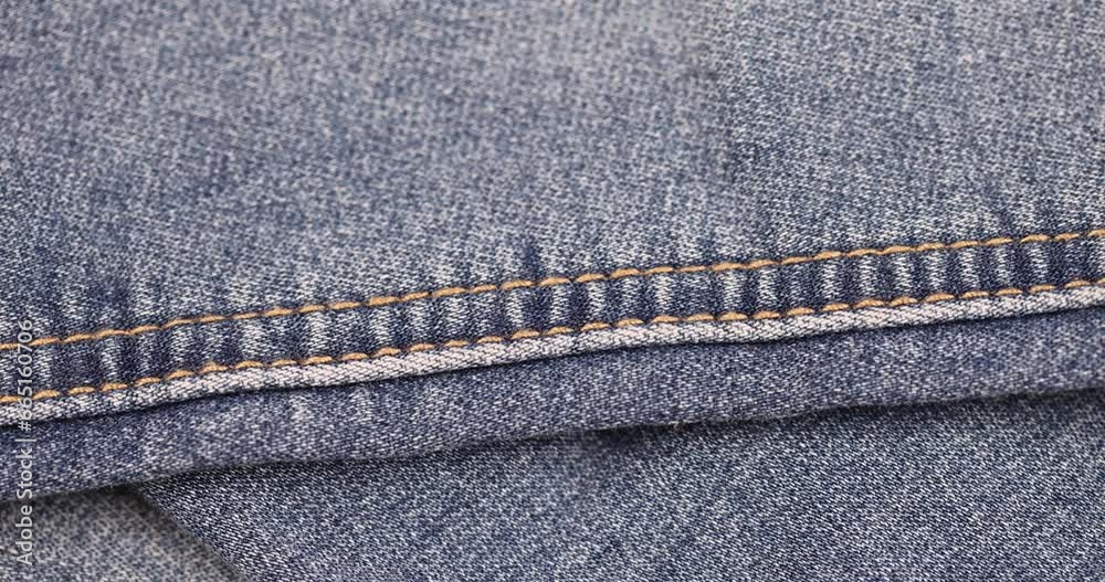 blue denim fabric made of cotton, details of a piece of clothing sewn from blue denim blue denim fabric made of cotton, details of a piece of clothing sewn from blue denim