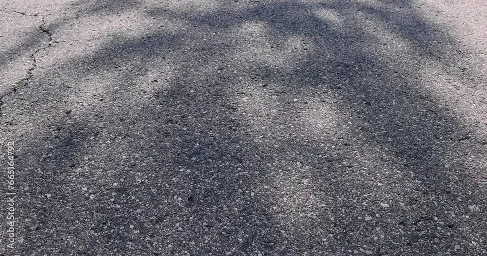 asphalting a new highway with black new asphalt, a close-up of a part of a new paved road asphalting a new highway with black new asphalt, a close-up of a part of a new paved road