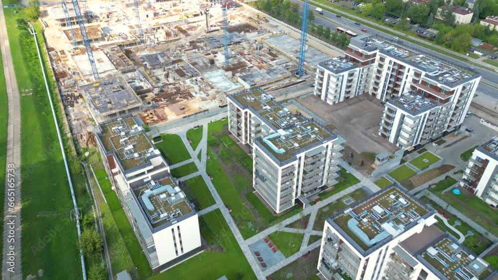 Aerial Bird Eye View Of a Construction Site Building Cranes Looking Down Industrial Machinery Area around Residential Urban Apartments