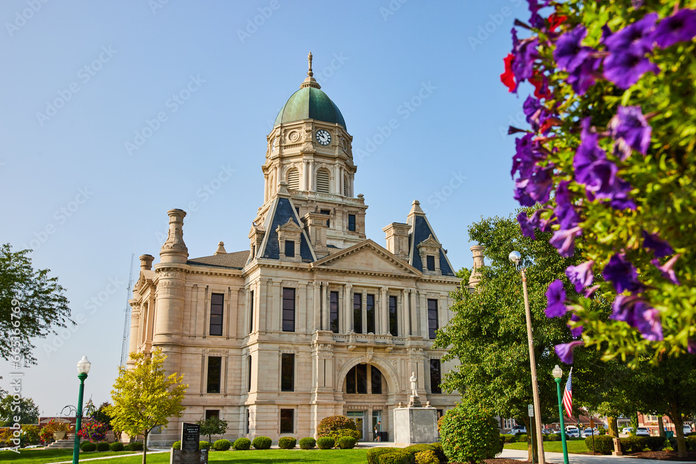 Columbia city courthouse with red and purple flowers on side of shot on sunny day