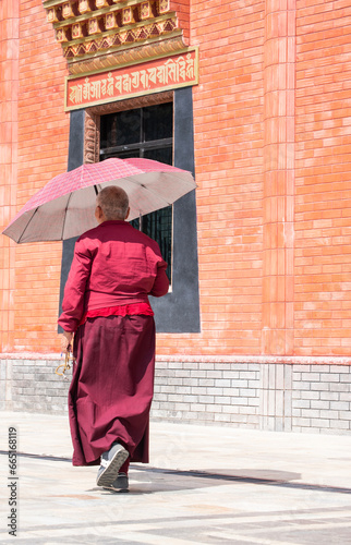 Dakshinkali, Nepal, 10-10-2023: a tibetan monk at the monastery of Guru Rinpoche (Padmasambhava), tantric Buddhist Vajra master, built in 2012, overlooking Dollu and Pharping monasteries photo