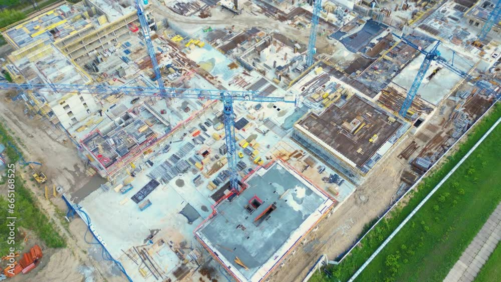 Aerial Bird Eye View Of a Construction Site Building Cranes Looking Down Industrial Machinery Area around Residential Urban Apartments Aerial Bird Eye View Of a Construction Site Building Cranes Looking Down Industrial Machinery Area around Residential Urban Apartments