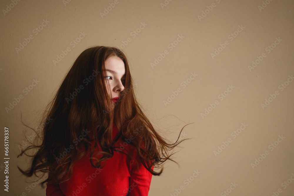 Close up young attractive woman 20s in red turtleneck isolated on plain pastel beige background studio. People lifestyle concept Close up young attractive woman 20s in red turtleneck isolated on plain pastel beige background studio. People lifestyle concept