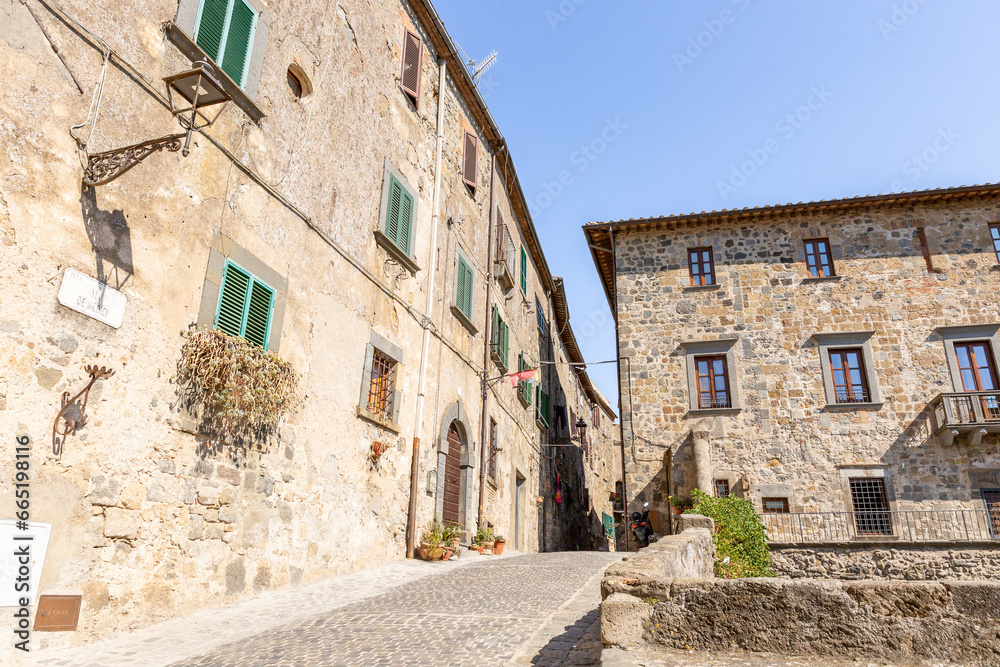 a cobbled street with traditional houses in Bolsena, province of Viterbo, Lazio, Italy