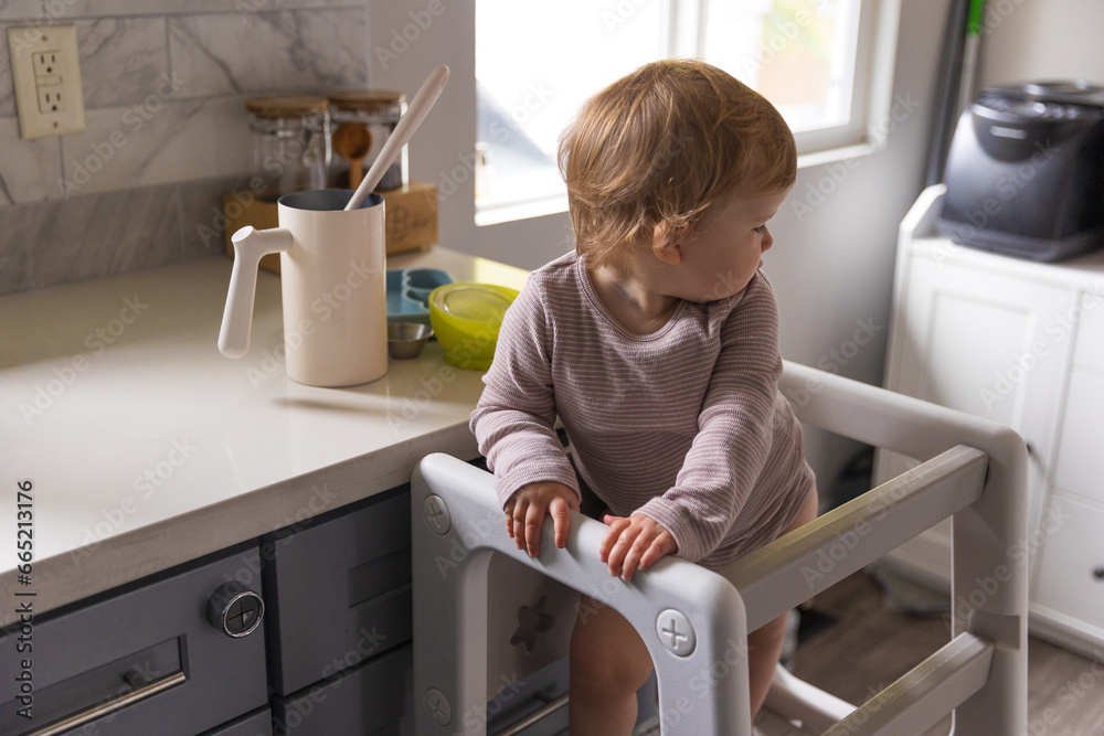 Toddler playing in the kitchen with household objects Toddler playing in the kitchen with household objects