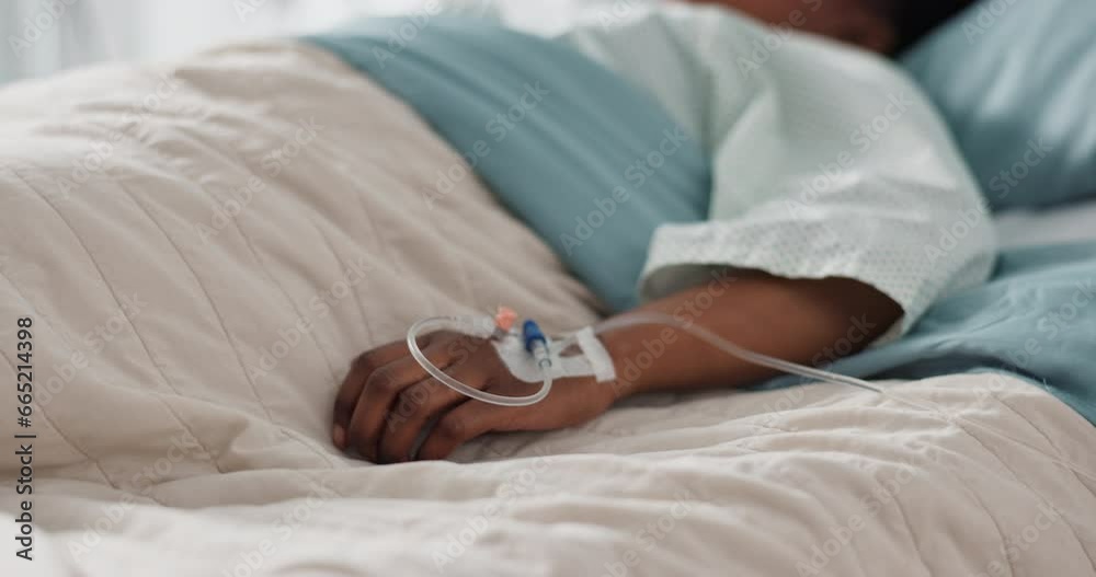 Healthcare, hand and iv with a patient in a hospital bed for recovery or rehabilitation closeup. Medical, wellness and treatment with a sick person lying in a clinic on a saline solution drip