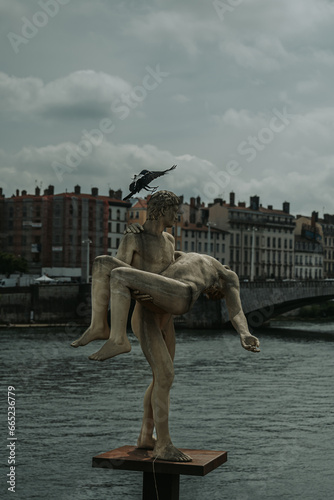 A status in Lyon facing the river