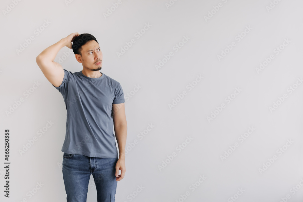 Confused face of asian man in blue t-shirt stand isolated on white. Confused face of asian man in blue t-shirt stand isolated on white.