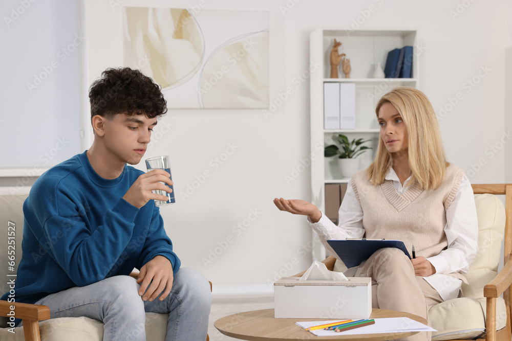 Psychologist working with teenage boy in office. Teenager problems Psychologist working with teenage boy in office. Teenager problems