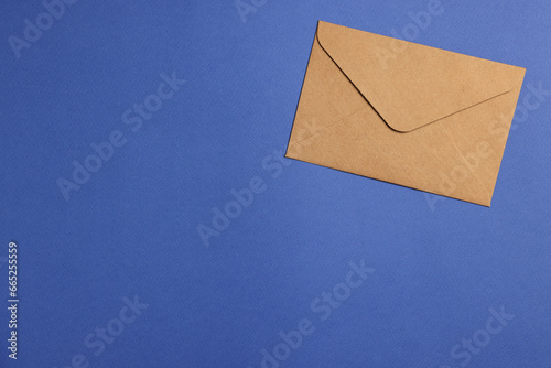 Envelope made of parchment paper on blue background, top view. Space for text