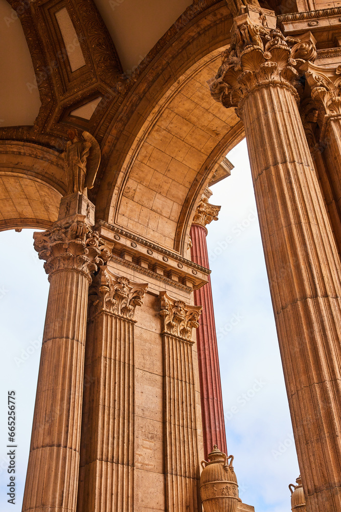Upward view of open rotunda ancient roman pillars and statues at Palace of Fine Arts