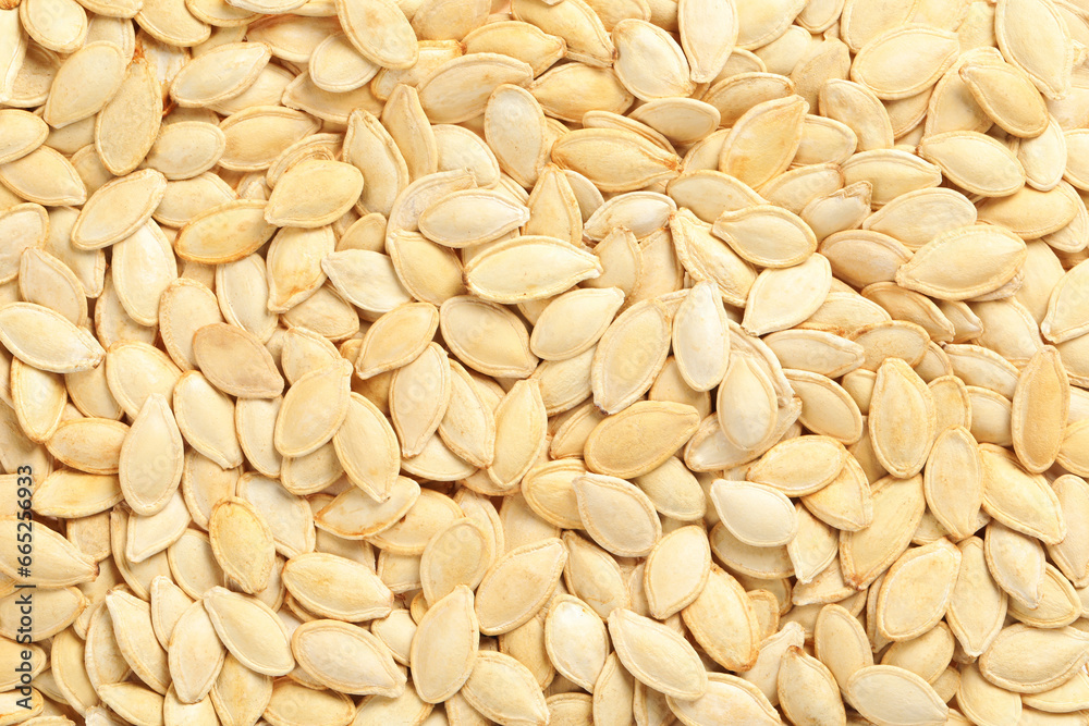 Many pumpkin seeds as background, top view Many pumpkin seeds as background, top view