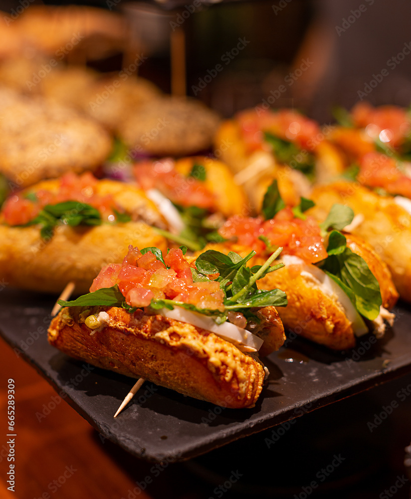 Arugula, tomato, mozzarella pintxos on a tray Arugula, tomato, mozzarella pintxos on a tray