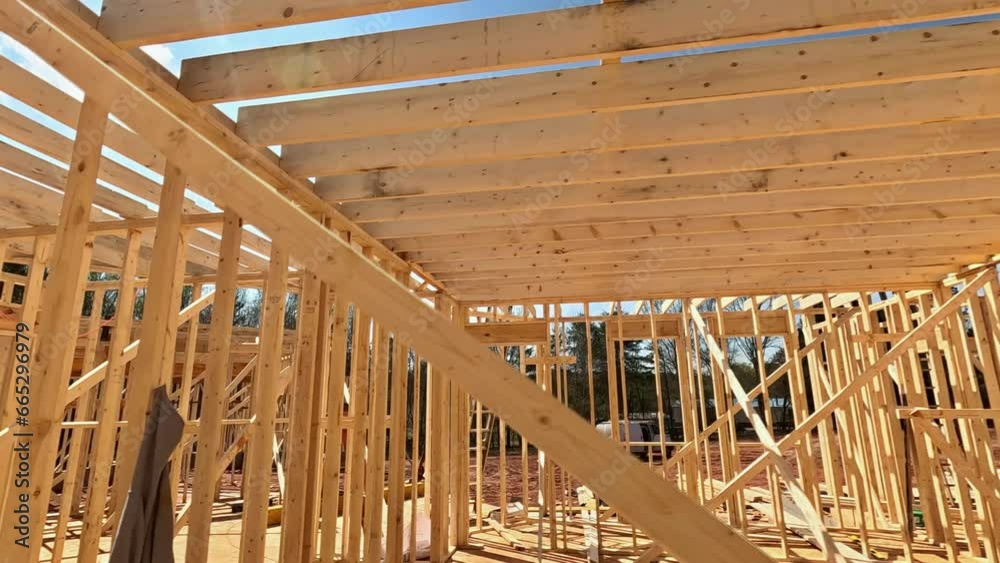 Inside frame wooden beams are utilized to support construction of new house Inside frame wooden beams are utilized to support construction of new house