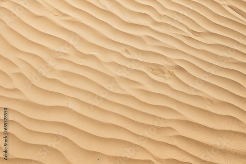 Closeup of sand pattern of a beach in the summer. © Dibos