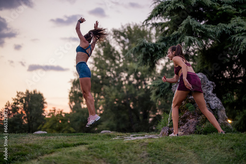 Active Females Enjoying Fun Moments in an Evening Park - Fitness, Flexibility, and Strength Training in Nature