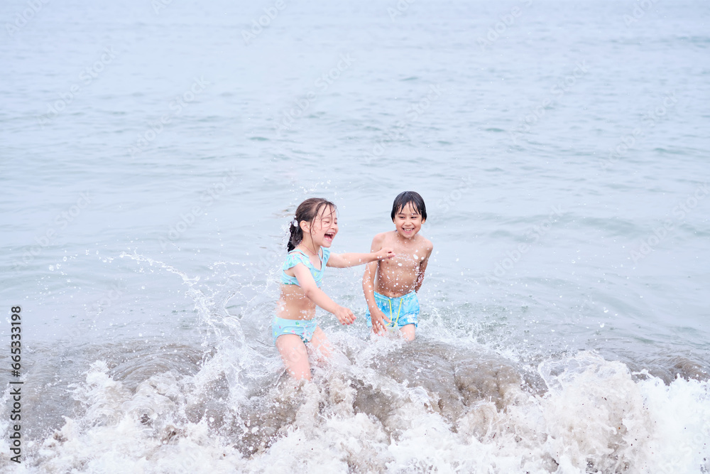 A boy and a girl are having fun playing in the sea. A boy and a girl are having fun playing in the sea.