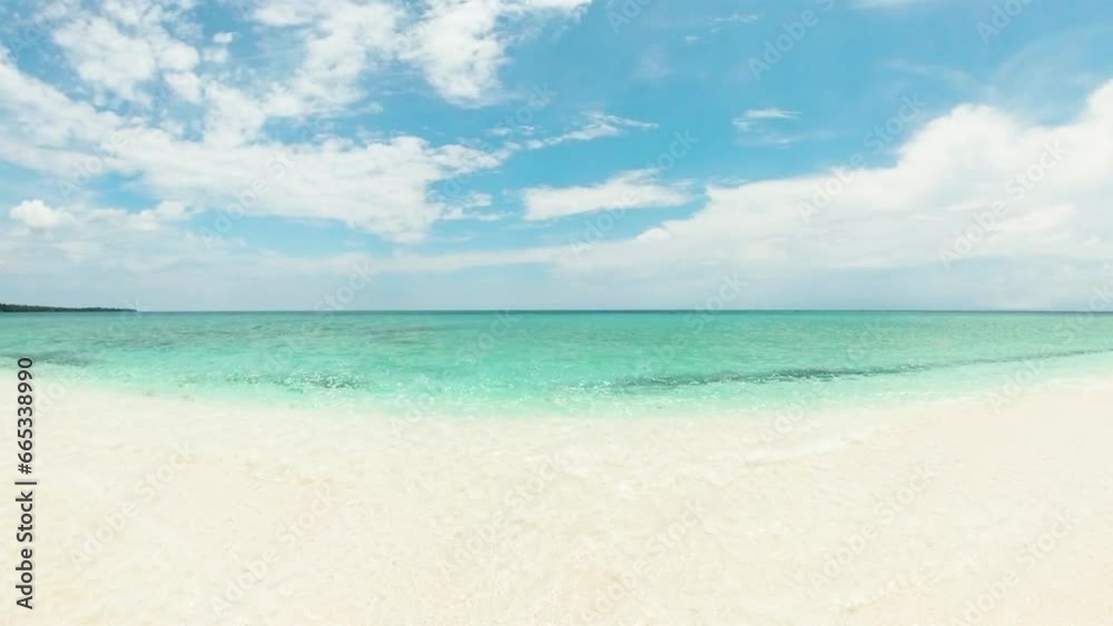 White sandbar surrounded by clear ocean water and waves. White Island in Camiguin, Philippines. White sandbar surrounded by clear ocean water and waves. White Island in Camiguin, Philippines.