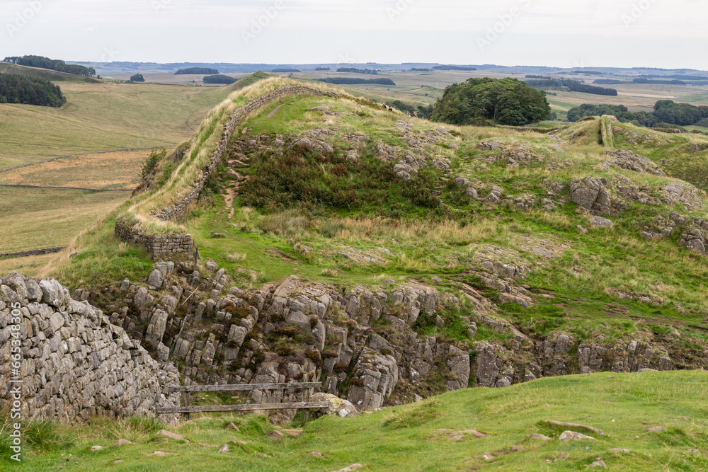 looking across at Hadrian's Wall winding across craggy hills near Housesteads, Northumberland, UK