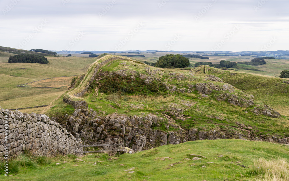 looking across at Hadrian's Wall winding across craggy hills near Housesteads, Northumberland, UK
