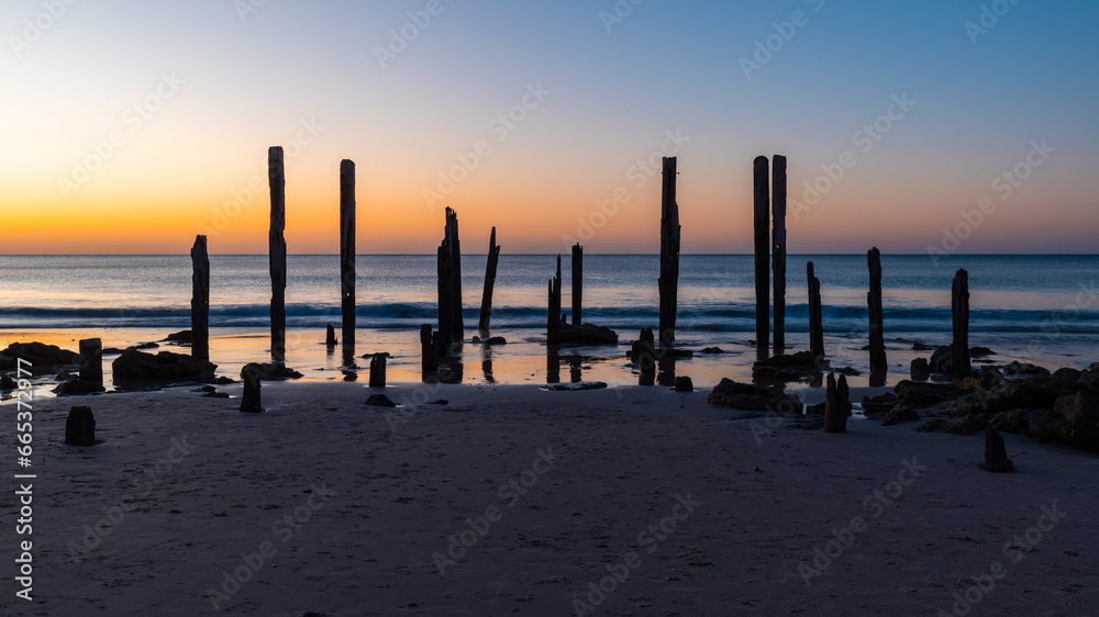 Silhouette of jetty pylons at Port Willunga, South Australia.