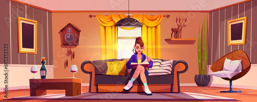 Bilde på lerret Young woman on couch reads book in living room