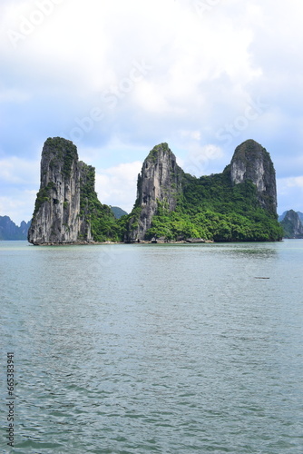 HA LONG BAY, VIETNAM - JULY 19, 2022: Beautiful view of the Halong bay, Vietnam. UNESCO World Heritage. This was on a cloudy day, with many boats and spells of sunshine. during the Covid 19 pandemic. 