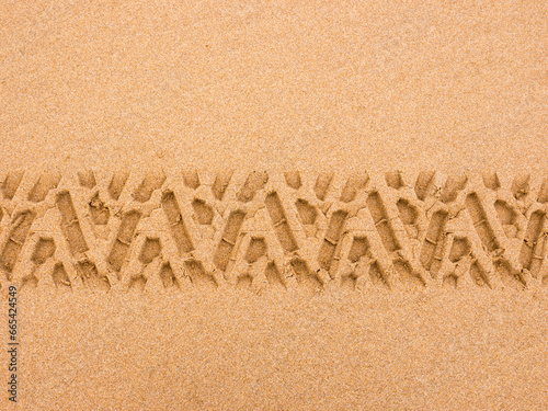 Tyre tread pattern in beach sand