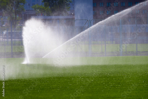 automatic watering of the football field lawn for training.