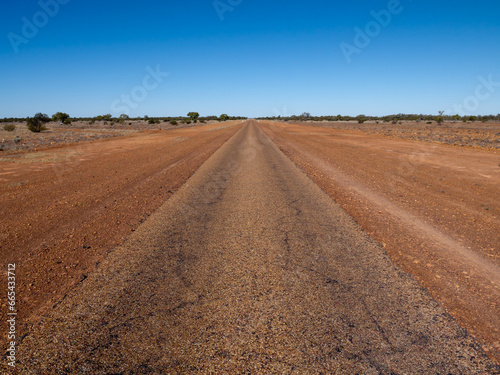 Straight single laned sealed road disappearing in the distance photo
