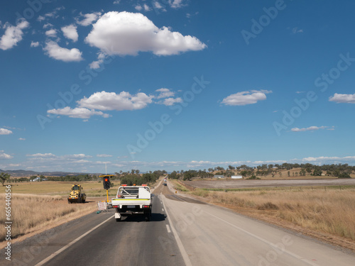 Road works with a vehicle at the stop signals photo