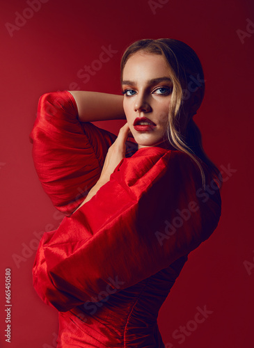 Portrait of a beautiful young woman with smooth fair skin. The head of a woman in an airy white shawl. Flying white, transparent fabric.