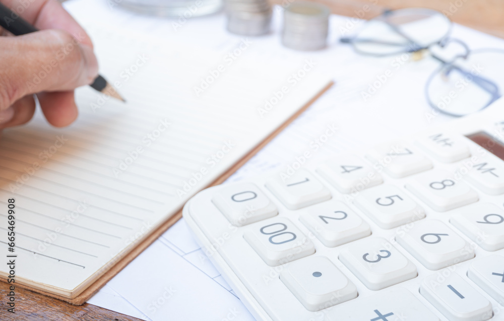 Calculator on financial statements and balance sheet on the desk of an accountant. Concept of accounting and audit business. Calculator on financial statements and balance sheet on the desk of an accountant. Concept of accounting and audit business.
