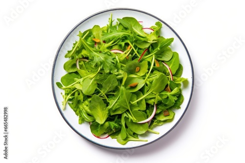 Healthy fresh green salad plate shot from above on white background.