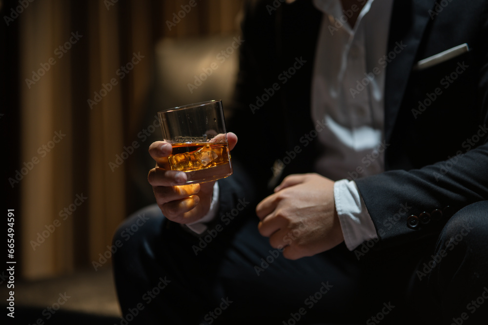 Businessman wearing a suit whiskey glass of liquor.Businessman wearing a suit whiskey glass of liquor.