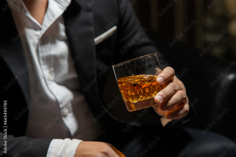 Businessman wearing a suit whiskey glass of liquor.Businessman wearing a suit whiskey glass of liquor. Businessman wearing a suit whiskey glass of liquor.Businessman wearing a suit whiskey glass of liquor.