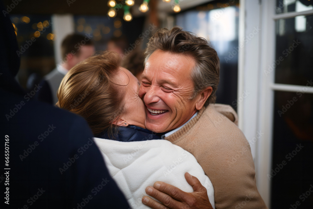 Fototapeta premium Mature friends or couple sharing a heartfelt moment, embracing warmly in a dimly lit social setting, with expressions of genuine happiness and connection.