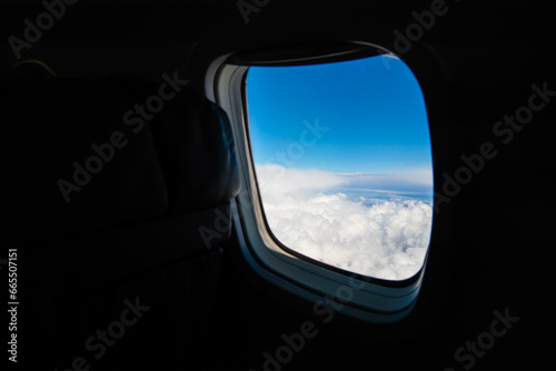 View from the window of the aircraft on the wing. Aairplane window with clouds view. Travel by airplane concept. 