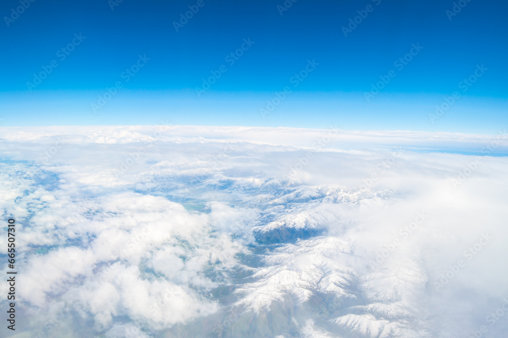 White clouds on blue sky background close up, cumulus clouds high in azure skies. flight over the clouds. view of the clouds from the airplane window. 