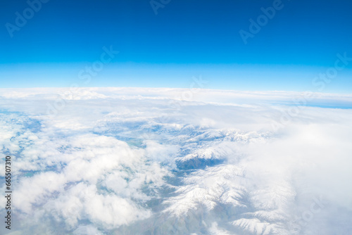 White clouds on blue sky background close up, cumulus clouds high in azure skies. flight over the clouds. view of the clouds from the airplane window. 