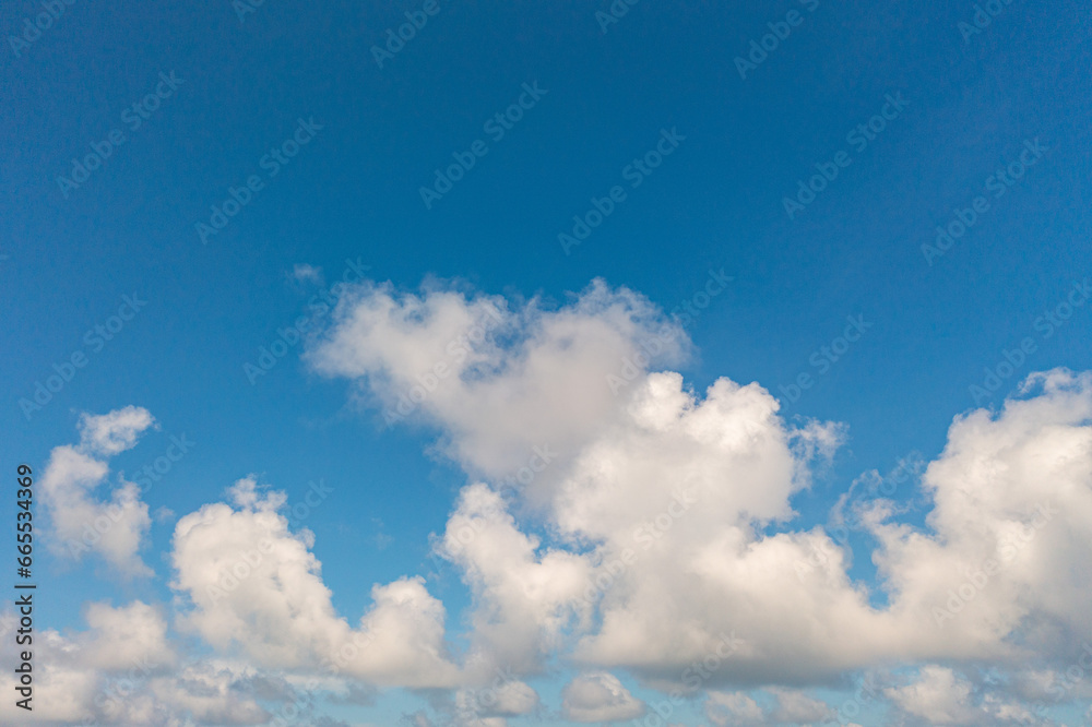 .The sky was a brilliant blue, dotted with white clouds that moved gracefully across the horizon..The wind gently blew them to and fro, seemingly without direction. .abstract sky nature background. .The sky was a brilliant blue, dotted with white clouds that moved gracefully across the horizon..The wind gently blew them to and fro, seemingly without direction. .abstract sky nature background.