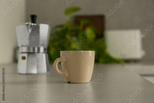 One ceramic cup on light grey countertop in kitchen