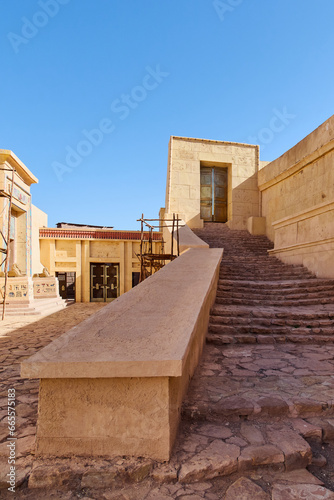 Stone staircase and wooden door in the desert of a village in Egypt.