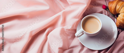 Pink mockup with breakfast, croissant, cup of coffee on linen sheet. Top view. breakfast on bed Morning relax,ambience. Hotels bedroom. Fall or winter leisure.Still life composition.Generative ai.