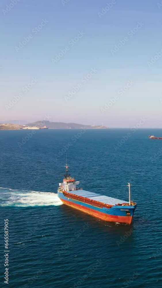 Aerial view of Cargo bulk vessel manoeuvring before entering port. vertical shot Aerial view of Cargo bulk vessel manoeuvring before entering port. vertical shot