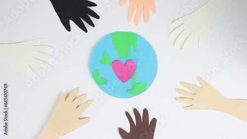 African american people together. Earth day postcard close up. Stop motion paper animation. Show love gesture. Racial unity concept. Black antiracism sign. Pink heart beat. Eco art card. Green globe. photo