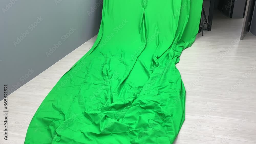 Green screen chroma key fabric canvas backdrop inside studio. Photoshoot and photography concept
