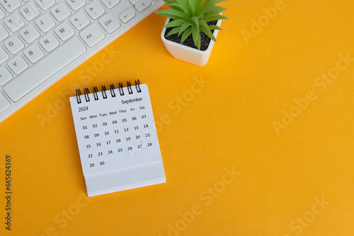 September 2024 desk calendar on yellow background. Directly above. Flat lay.