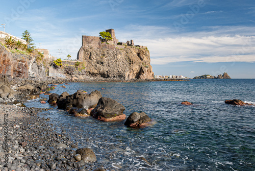 The norman castle of Aci Castello in eastern Sicily, built on a lava rock promontory photo