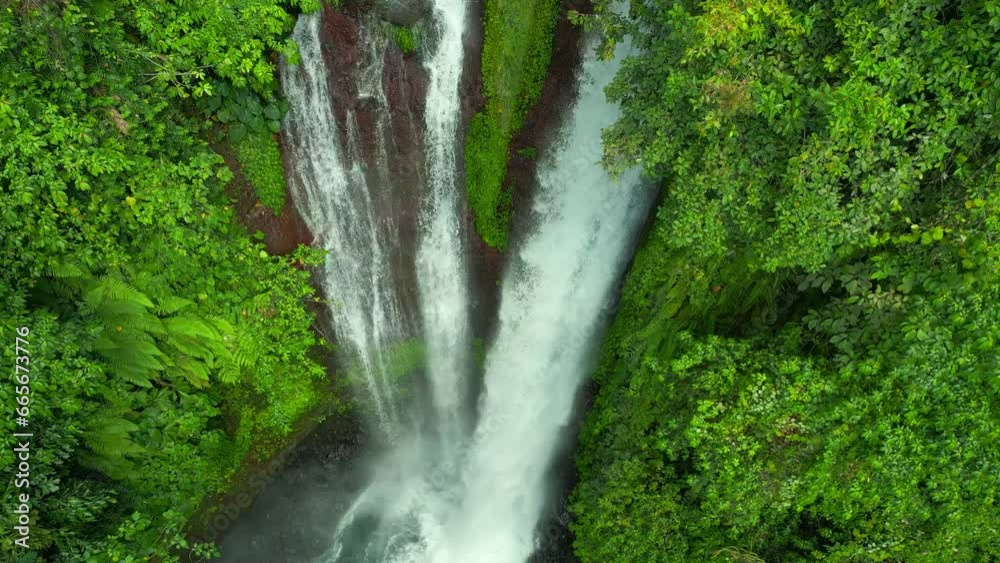Aerial drone view of beautiful Aling Aling waterfall in nothern Bali, Indonesia.